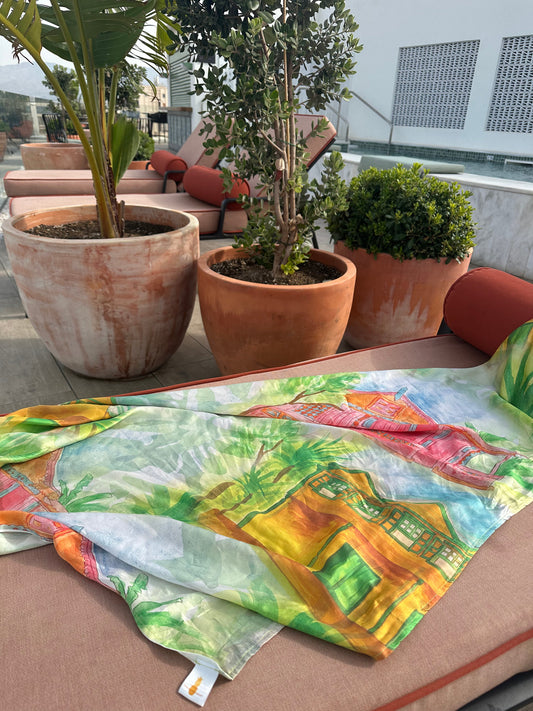 colourful printed silk scarf draped on a sun lounger